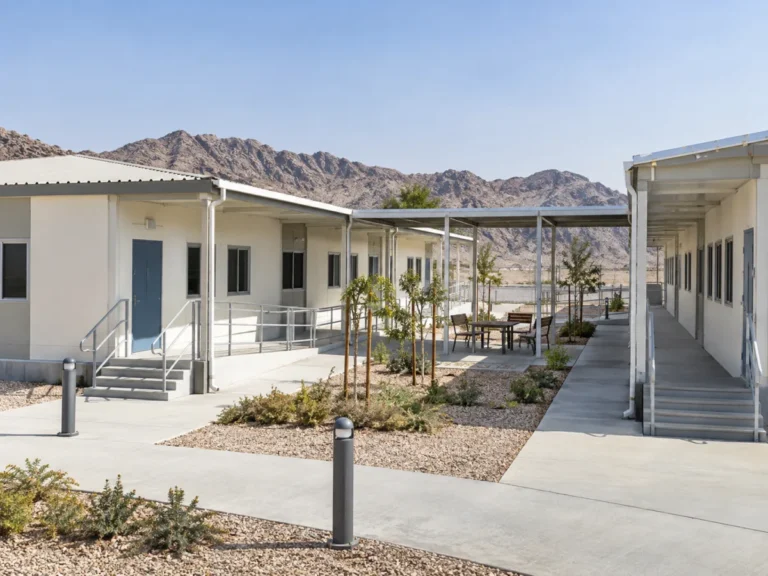 Single-storey staff accommodation buildings connected by covered walkways